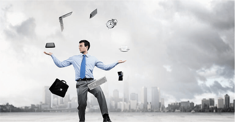 Young businessman juggling with business items against urban scene