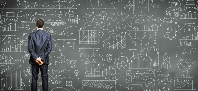 Business person standing against the blackboard with a lot of data written on it