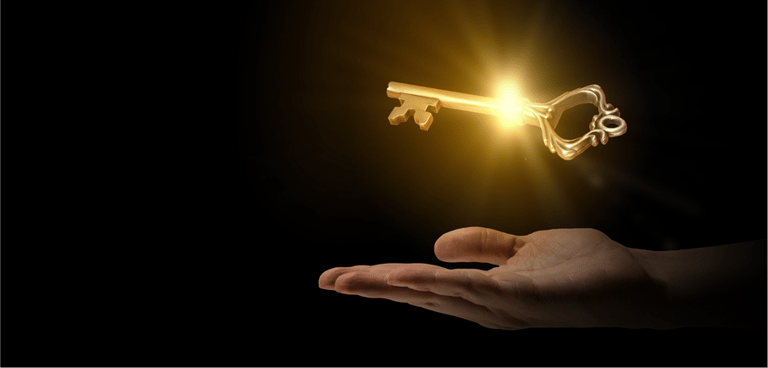 Close up of human hand holding golden key
