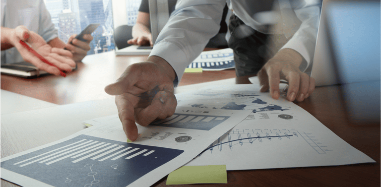 Double exposure of businessman hand working with new modern computer and business strategy as concept