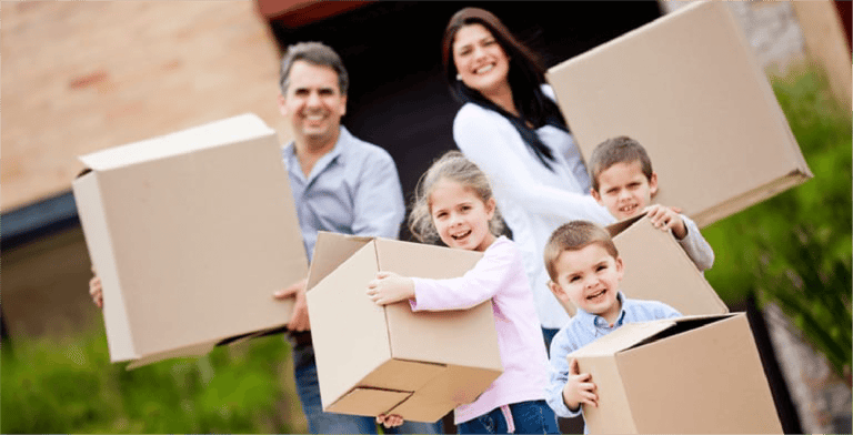 Happy family moving house and carrying boxes