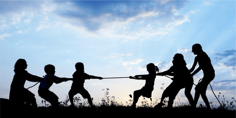 Kids playing tug war pulling rope