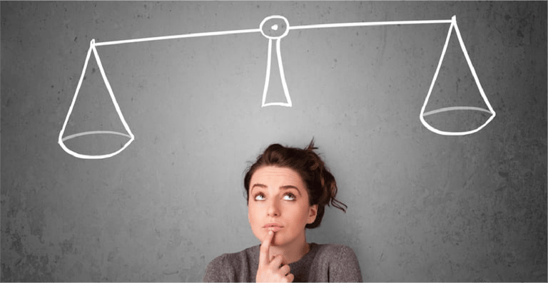 Pretty young lady taking a decision with scale above her head